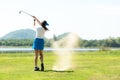 Golfer sport course golf ball fairway. People lifestyle woman playing game golf and hitting out of sand trap go on green grass. Royalty Free Stock Photo